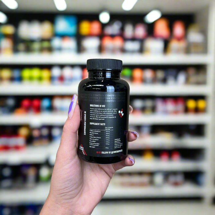 Close-up of (Conteh Pre Shred 90 Capsules) held up inside My Supplement Shop, clearly showing Nutritional Values on the packaging in a Sports Nutrition setting