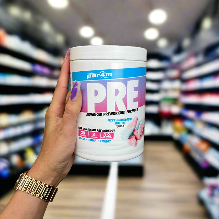 Close-up of (Per4m Pre Workout Stim 570g 30 Servings) held up inside My Supplement Shop, clearly showing the front label in a Sports Nutrition setting.